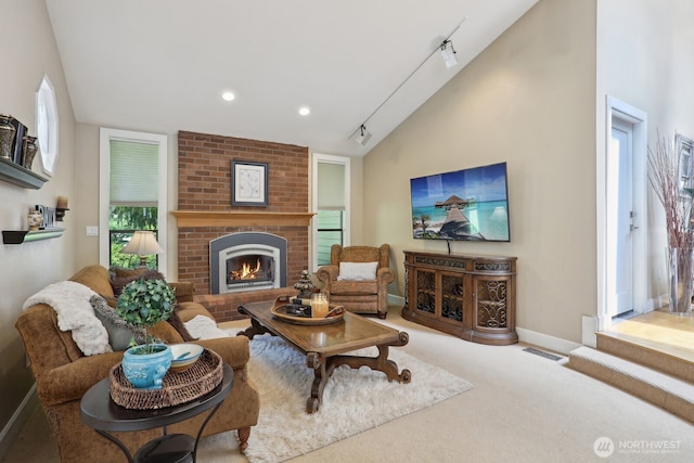 carpeted living area featuring vaulted ceiling, baseboards, a fireplace, rail lighting, and recessed lighting
