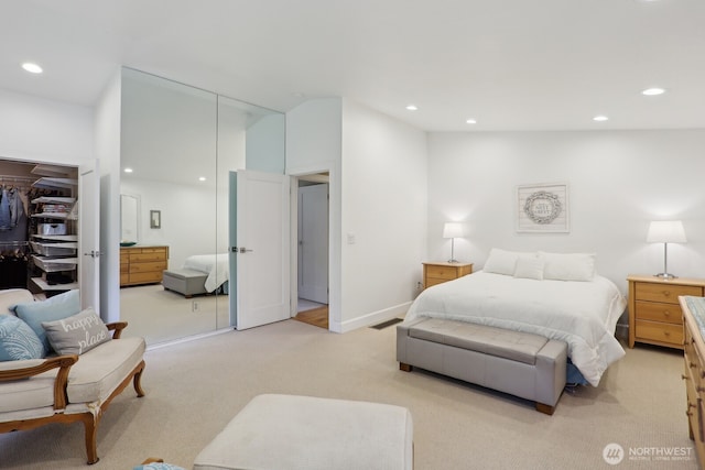 bedroom with light carpet, a closet, and recessed lighting