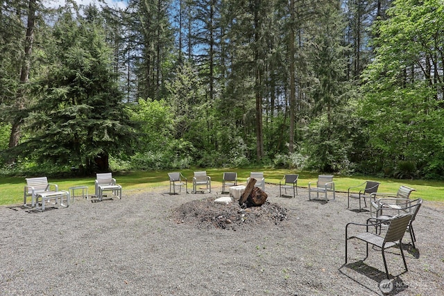 view of community featuring a yard and a fire pit