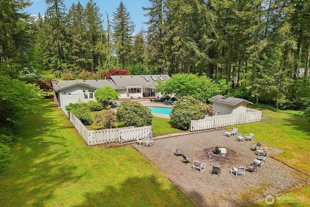 rear view of house featuring an outdoor pool, a patio area, and an outdoor fire pit