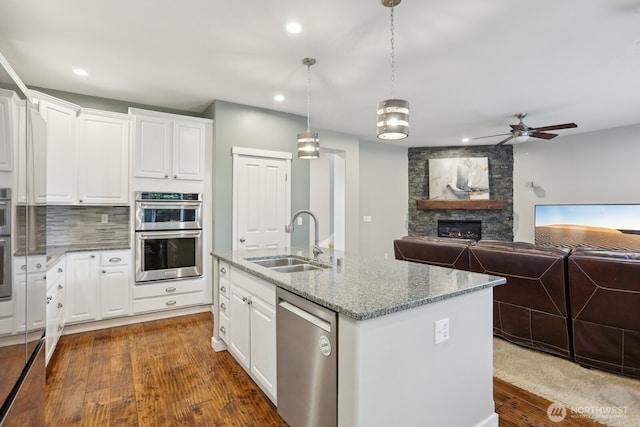 25510 SE 275th Pl, Maple Valley, WA 98038 - kitchen with stainless steel appliances, a sink, dark wood finished floors, white cabinetry, and a ceiling fan