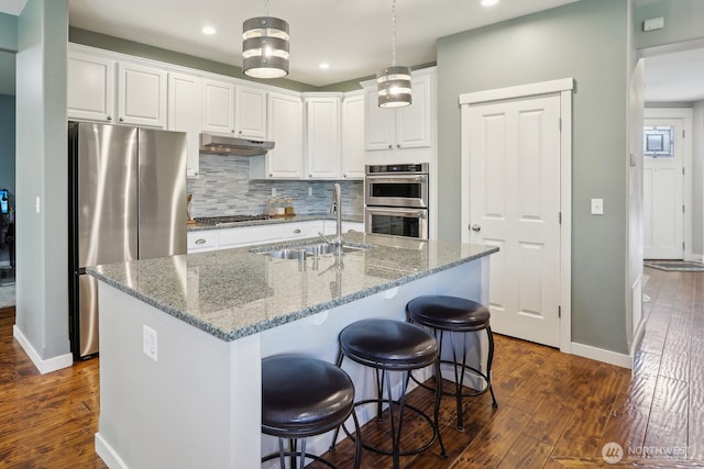 25510 SE 275th Pl, Maple Valley, WA 98038 - kitchen with appliances with stainless steel finishes, a sink, under cabinet range hood, dark wood-style floors, and white cabinets