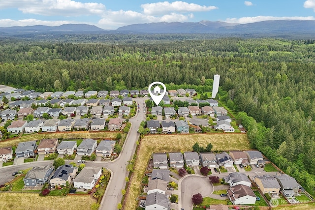 25510 SE 275th Pl, Maple Valley, WA 98038 - aerial overview of property's location featuring a heavily wooded area, a mountain backdrop, and nearby suburban area