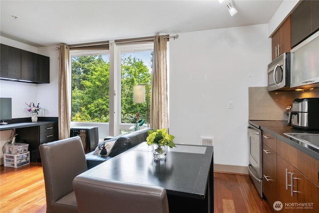 4547 8th Ave NE Unit 308, Seattle, WA 98105 - dining space with wood finished floors