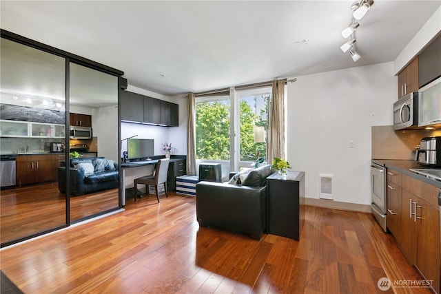 4547 8th Ave NE Unit 308, Seattle, WA 98105 - living room featuring light wood-style floors and heating unit