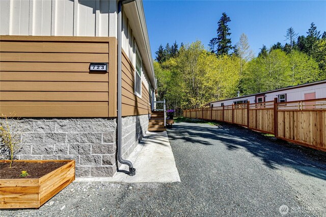 view of property exterior with fence and board and batten siding
