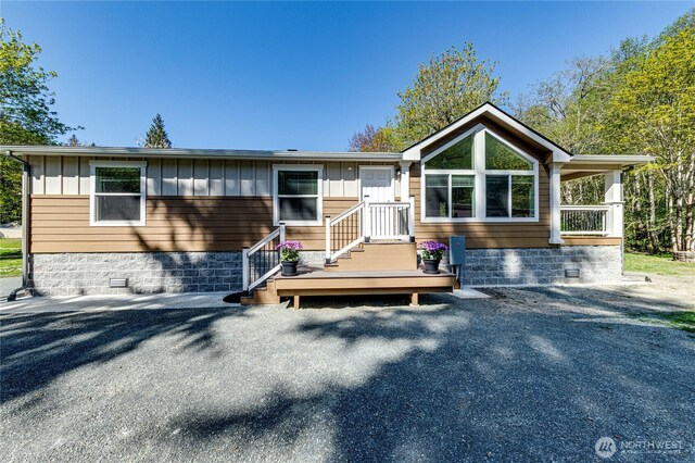 view of front of home featuring board and batten siding and crawl space