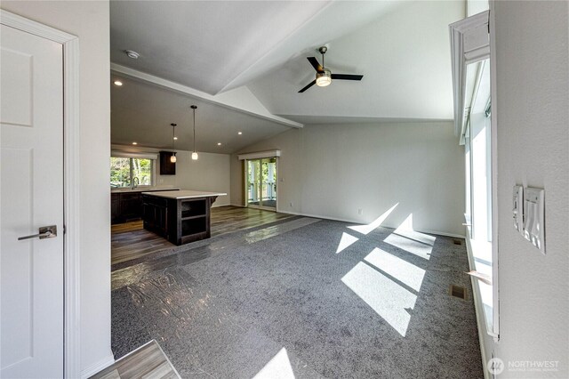 unfurnished living room featuring visible vents, ceiling fan, and vaulted ceiling