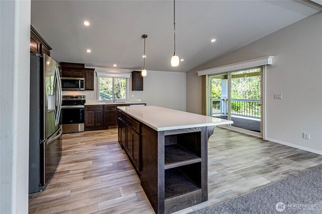 kitchen featuring dark brown cabinetry, stainless steel appliances, open shelves, light countertops, and a sink