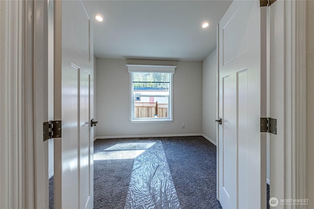 unfurnished bedroom featuring recessed lighting, dark carpet, and baseboards