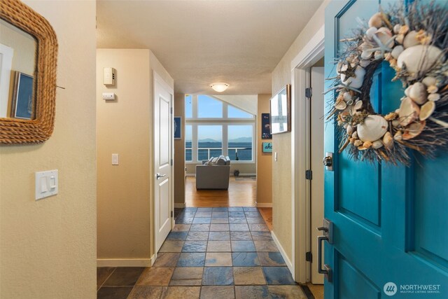 192 Fay Ln, Camano Island, WA 98282 - hallway featuring baseboards and stone tile flooring