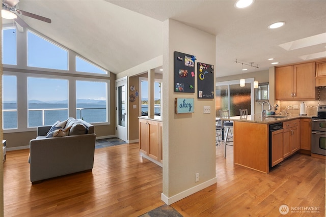 192 Fay Ln, Camano Island, WA 98282 - kitchen with double oven range, a sink, open floor plan, light wood-style floors, and paneled dishwasher