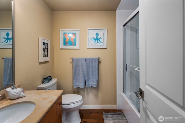 192 Fay Ln, Camano Island, WA 98282 - full bath featuring vanity, toilet, enclosed tub / shower combo, baseboards, and wood finished floors