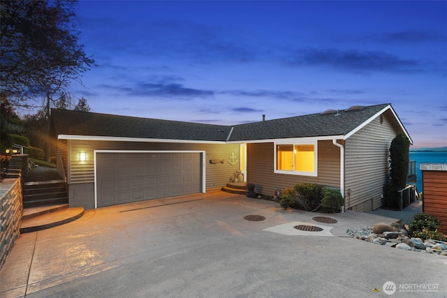 192 Fay Ln, Camano Island, WA 98282 - ranch-style home featuring a garage, driveway, an outdoor fire pit, and roof with shingles