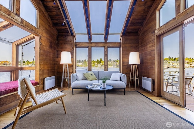 3123 Fairview Ave E Unit 2, Seattle, WA 98102 - living area featuring wooden walls, beam ceiling, heating unit, wood finished floors, and wood ceiling