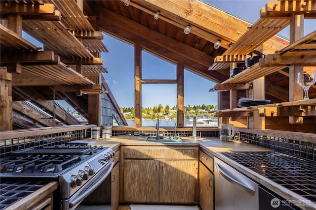 3123 Fairview Ave E Unit 2, Seattle, WA 98102 - kitchen featuring a sink, decorative backsplash, lofted ceiling with beams, and stainless steel appliances