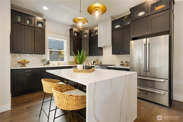 421 Malden Ave E, Seattle, WA 98112 - kitchen featuring high end refrigerator, a sink, backsplash, a kitchen island, and dark wood-style flooring