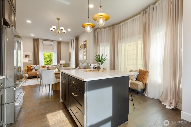 421 Malden Ave E, Seattle, WA 98112 - kitchen with open floor plan, high quality fridge, a wall mounted air conditioner, dark wood-style floors, and light countertops