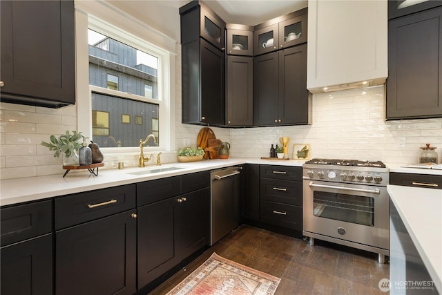 421 Malden Ave E, Seattle, WA 98112 - kitchen featuring appliances with stainless steel finishes, a sink, light countertops, backsplash, and dark wood-style floors