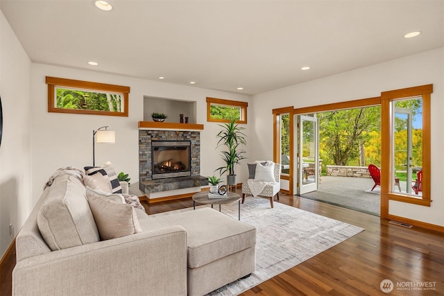living area with plenty of natural light, recessed lighting, visible vents, and a fireplace