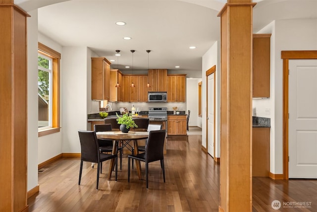dining space with recessed lighting, baseboards, and dark wood finished floors