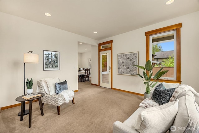 carpeted living area with baseboards and recessed lighting