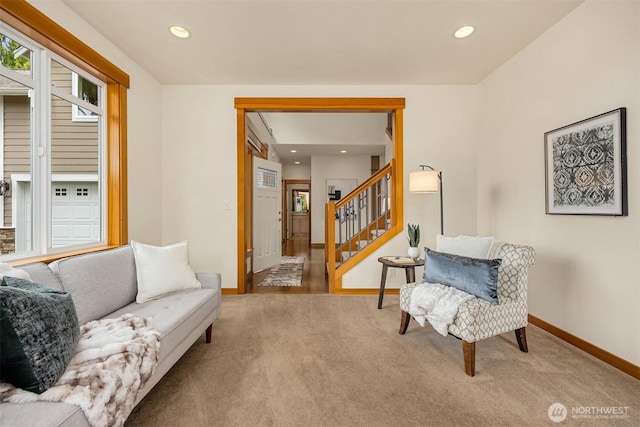 carpeted living room with recessed lighting, baseboards, and stairs