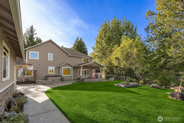 back of house featuring a patio and a lawn