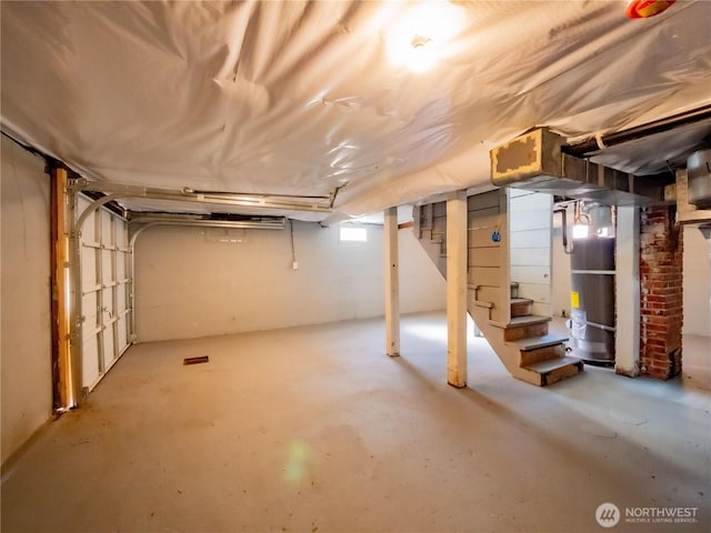 basement featuring secured water heater and stairway