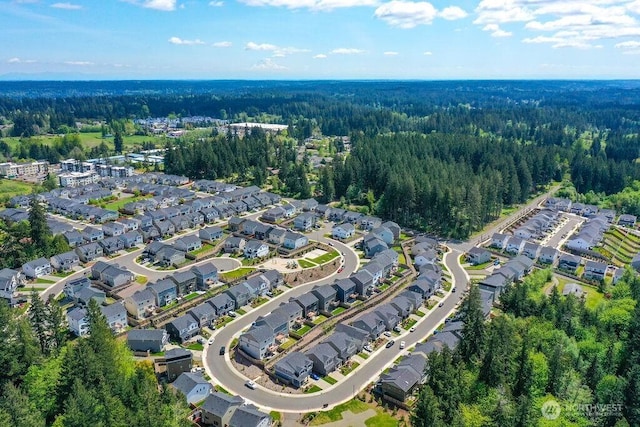 birds eye view of property with a view of trees and a residential view