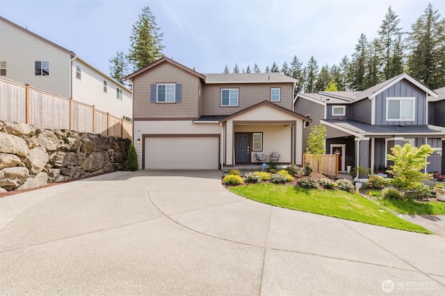view of front of home featuring a garage, fence, covered porch, board and batten siding, and concrete driveway