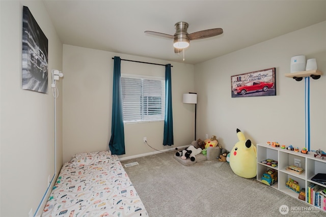 unfurnished bedroom featuring a ceiling fan, baseboards, visible vents, and carpet