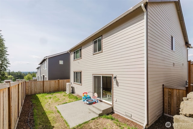 back of house featuring a fenced backyard and a patio