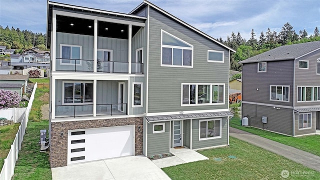152 Henning Dr, Camano Island, WA 98282 - modern home featuring a balcony, board and batten siding, stone siding, driveway, and a garage