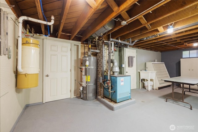 basement with water heater and a sink