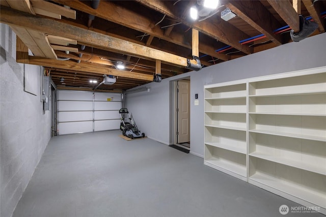 garage with a garage door opener and electric panel
