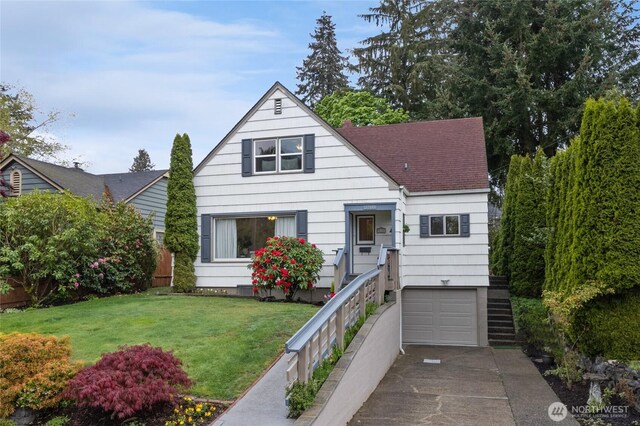 bungalow with a front yard, roof with shingles, concrete driveway, an attached garage, and stairway