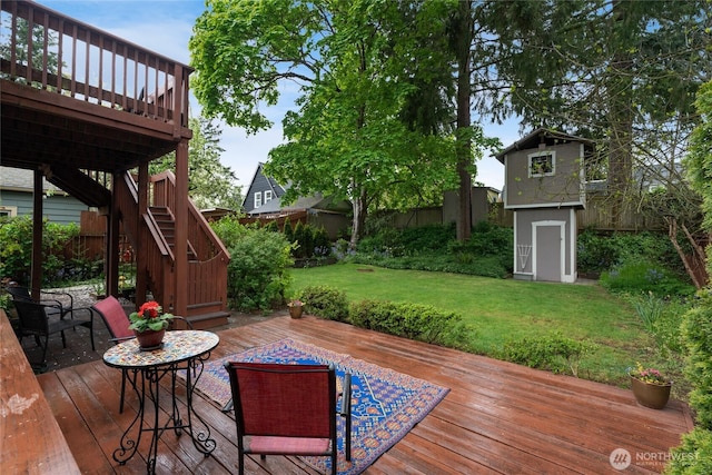 deck with stairs, a lawn, and fence