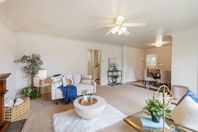 living area with carpet floors and ceiling fan