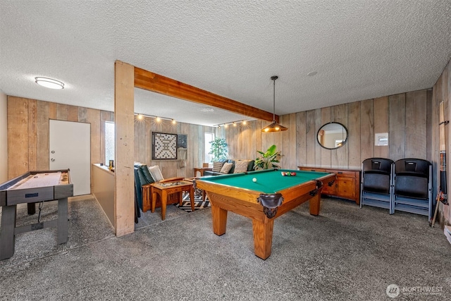 game room featuring billiards, a textured ceiling, wooden walls, and carpet flooring