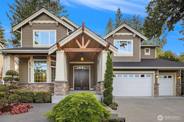craftsman house featuring stone siding, an attached garage, concrete driveway, and a shingled roof
