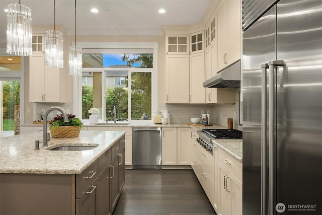 kitchen featuring stainless steel appliances, a sink, under cabinet range hood, white cabinets, and recessed lighting