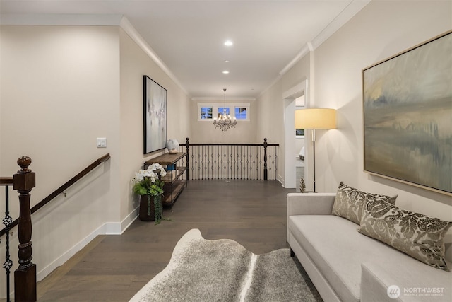 living area featuring wood finished floors, a chandelier, ornamental molding, recessed lighting, and baseboards