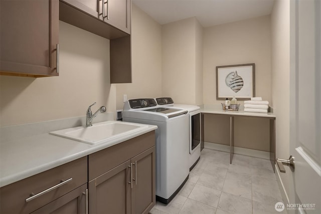 washroom with cabinet space and washing machine and clothes dryer