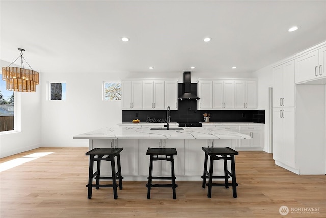 1322 114th St S, Tacoma, WA 98444 - kitchen featuring a sink, wall chimney exhaust hood, backsplash, and white cabinetry
