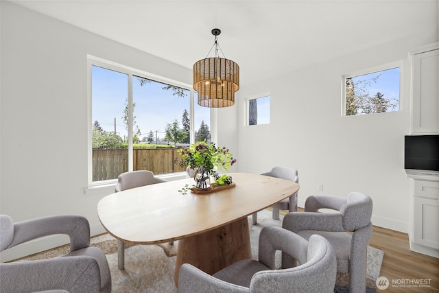1322 114th St S, Tacoma, WA 98444 - dining space with light wood-style floors and an inviting chandelier