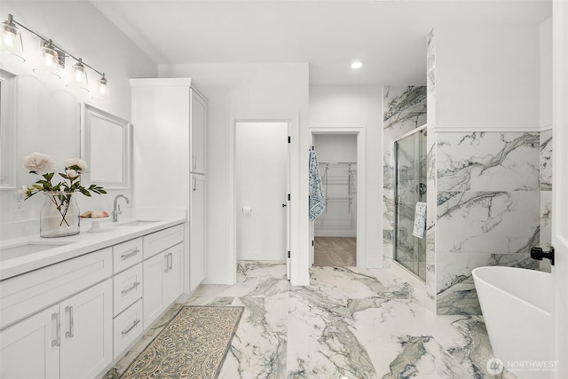 1322 114th St S, Tacoma, WA 98444 - bathroom with double vanity, a walk in closet, a freestanding tub, a sink, and a marble finish shower