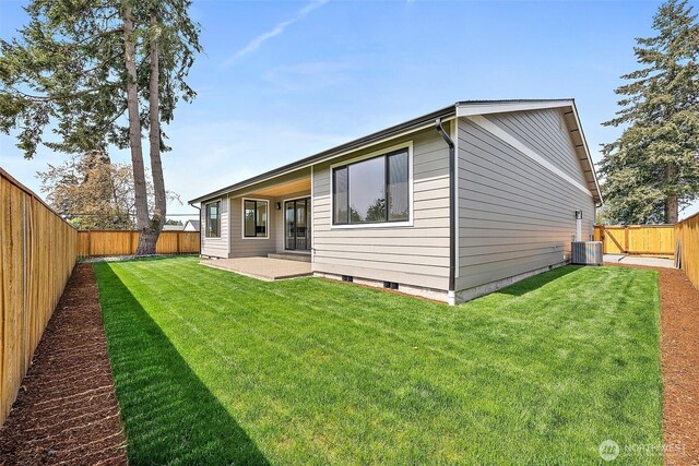 1322 114th St S, Tacoma, WA 98444 - rear view of house featuring a fenced backyard, a patio, a yard, and central air condition unit