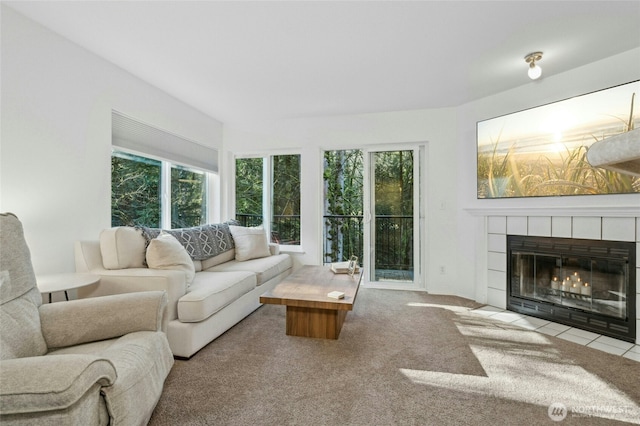carpeted living room with a fireplace