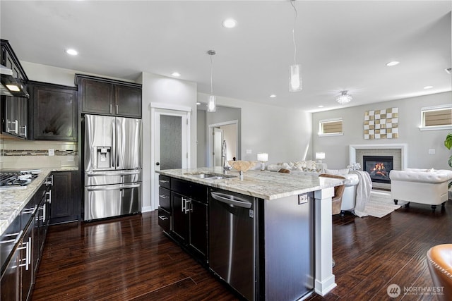 3804 193rd Pl SE, Bothell, WA 98012 - kitchen featuring an island with sink, a sink, stainless steel appliances, open floor plan, and dark wood-type flooring